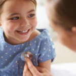 physician listening to child's heart